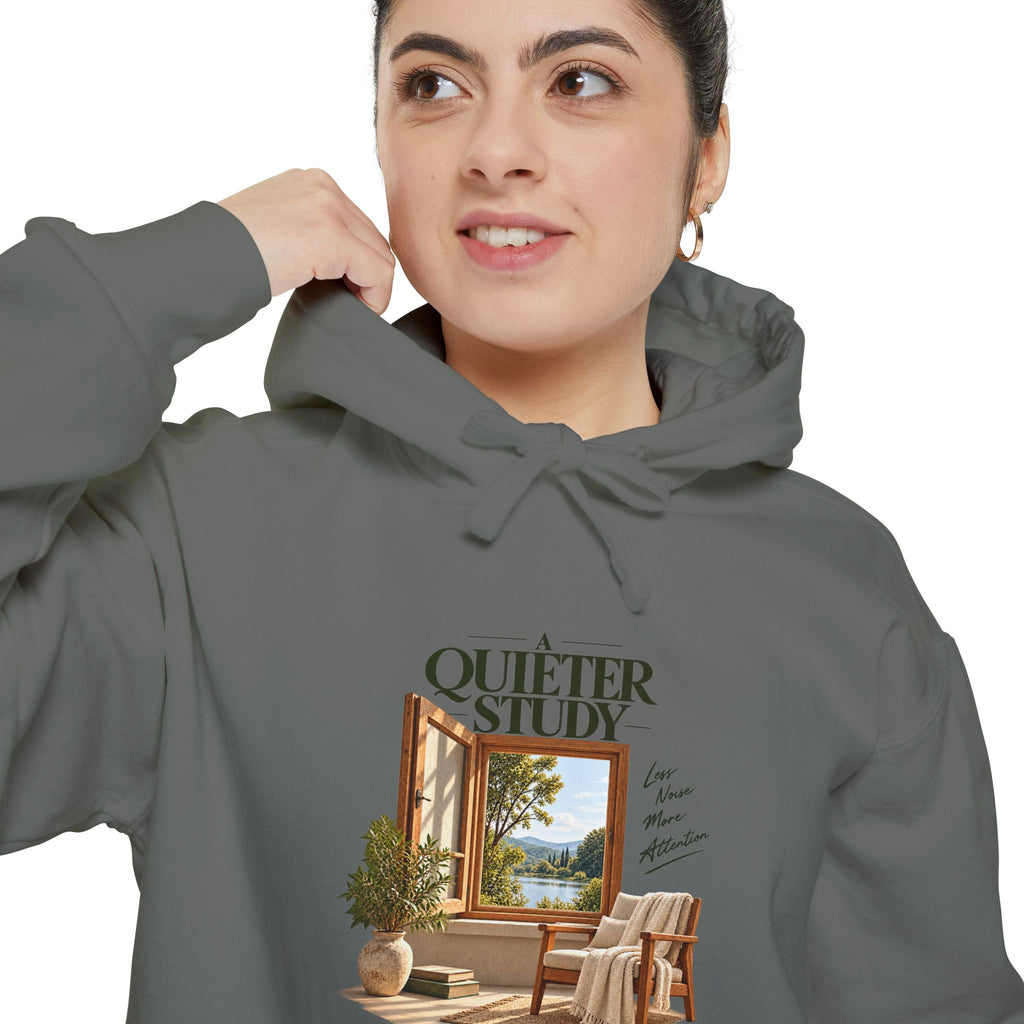 A Quieter Study Grey garment-dyed hoodie, close-up of the front print on a model, showing the window, chair and plant graphic.