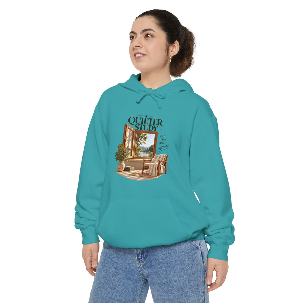 A Quieter Study Seafoam garment-dyed hoodie, modeled front view, showing the window, chair and plant graphic.