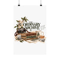 The Ordinary Archive matte art print hanging with clips, showing camera, books, flowers and paper collage