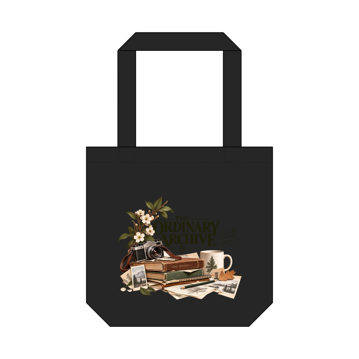 The Ordinary Archive black tote bag, front view with camera, books, blossoms and paper collage graphic