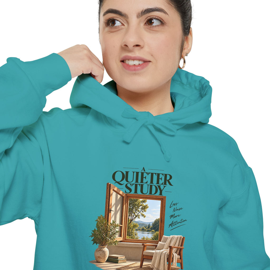 A Quieter Study Seafoam garment-dyed hoodie, close-up of the front print on a model, showing the window, chair and plant graphic.
